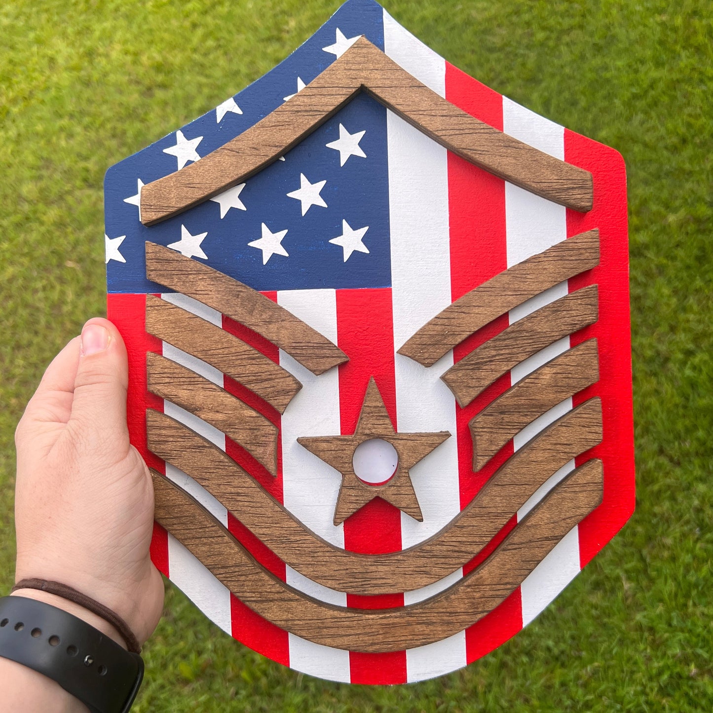 United States air force plqque that has an amerian flag background with starined 3D stripes on the front that are in the shape of Master Sergant air force rank